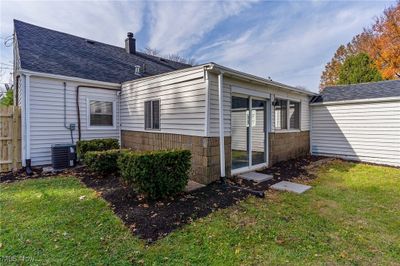 Back of house with central AC and a lawn | Image 3