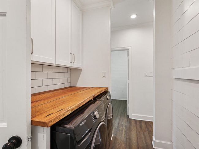 Laundry area with washer and clothes dryer, cabinet space, ornamental molding, dark wood-type flooring, and recessed lighting | Image 19