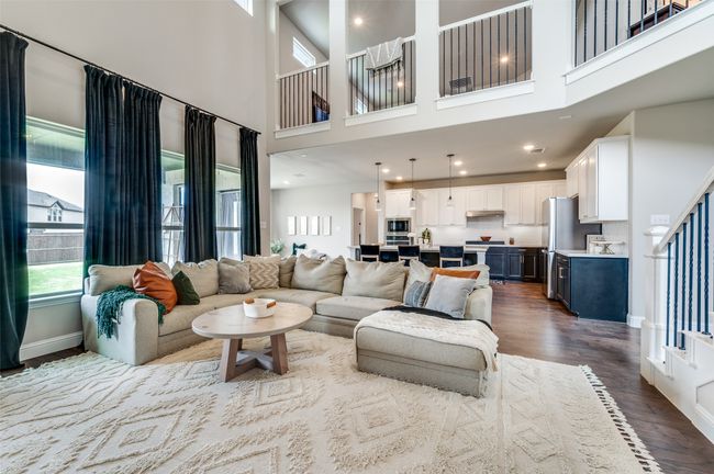 Living area with a high ceiling, baseboards, dark wood-style floors, and recessed lighting | Image 8