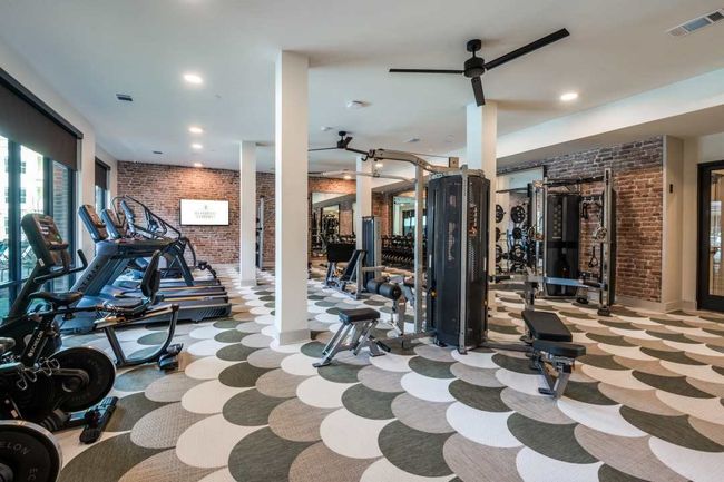 Exercise room with ceiling fan and brick wall | Image 40
