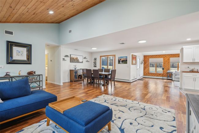 Living area featuring visible vents, lofted ceiling, recessed lighting, light wood-style floors, and wooden ceiling | Image 9