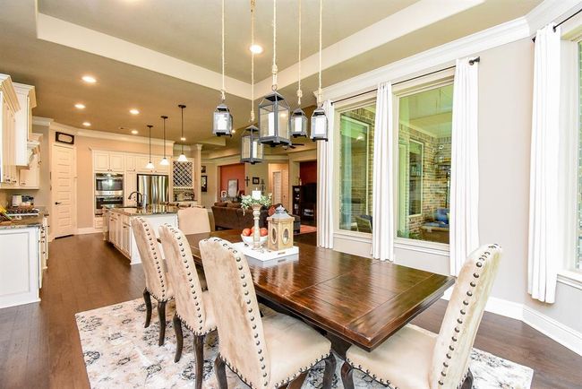 The dining area allows for a large table with seating for 10 or more guests! Or enjoy a smaller table and add another furniture piece like a buffet table or 2 chars as a sitting area at the end of the table. This home is a decorators dream! | Image 22