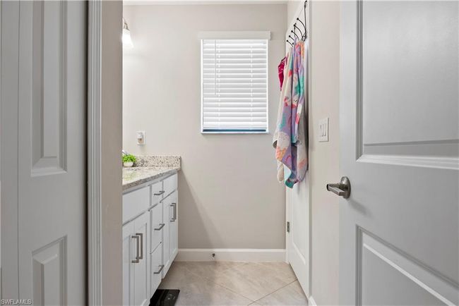 Bathroom featuring tile patterned floors, baseboards, and vanity | Image 28