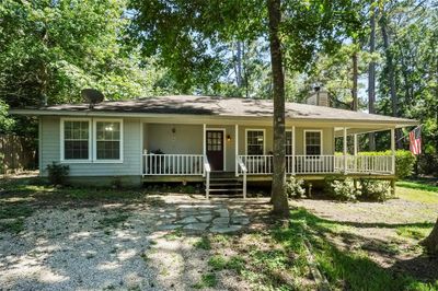 Home offers around 500 sq ft of wrap around covered porch. | Image 2