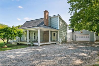 View of front of house with an outdoor structure, a garage, and a porch | Image 3