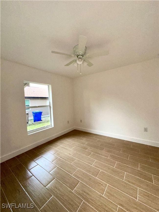 Unfurnished room with ceiling fan and hardwood / wood-style flooring | Image 15