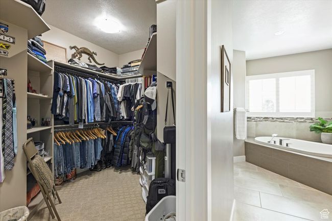 Spacious closet with tile patterned floors | Image 36