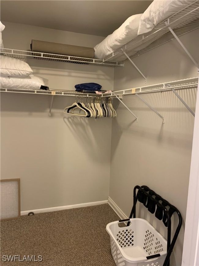 Walk in closet featuring carpet flooring | Image 16