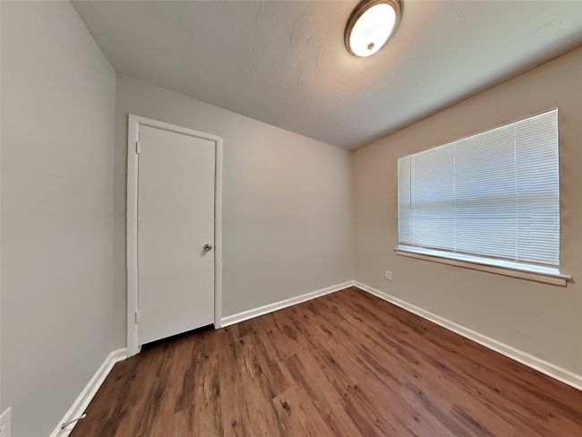Spare room with baseboards and dark wood-style floors | Image 8