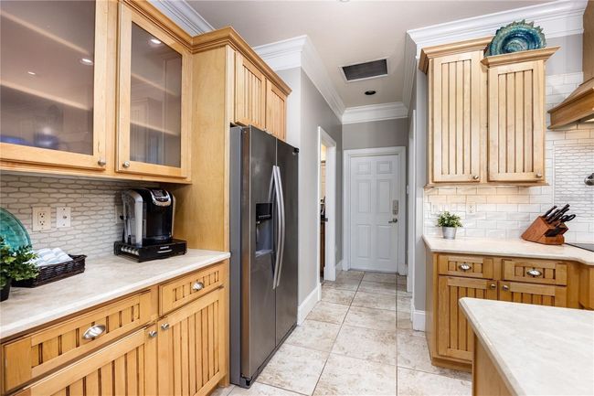 Fully upgraded kitchen with stainless steel appliances, custom cabinets, granite counters, large island with seating, and much more! | Image 9