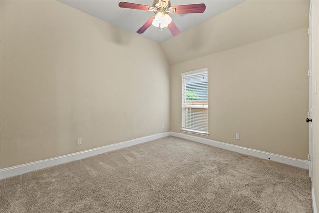 This is the first of 3 secondary bedrooms. All bedrooms feature ceiling fans and walk-in closets. | Image 9