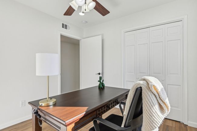 Office space with a ceiling fan, wood finished floors, and baseboards | Image 16