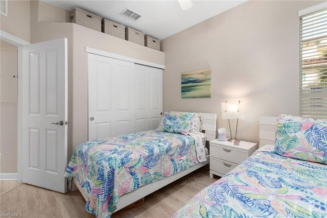 Bedroom with light hardwood / wood-style floors, a closet, and ceiling fan | Image 16