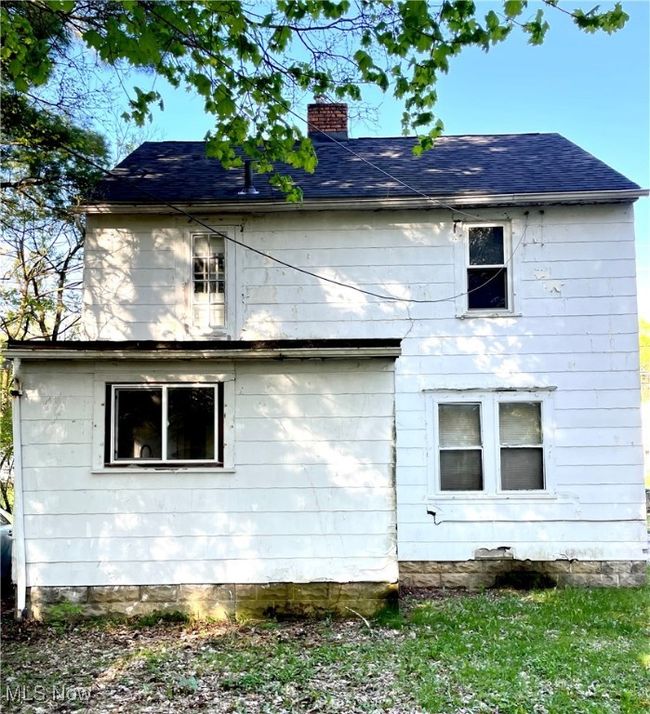 View of home's exterior with a chimney and a shingled roof | Image 23