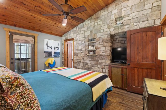 Primary retreat featuring lofted ceiling, wood ceiling, and dark wood finished floors | Image 35