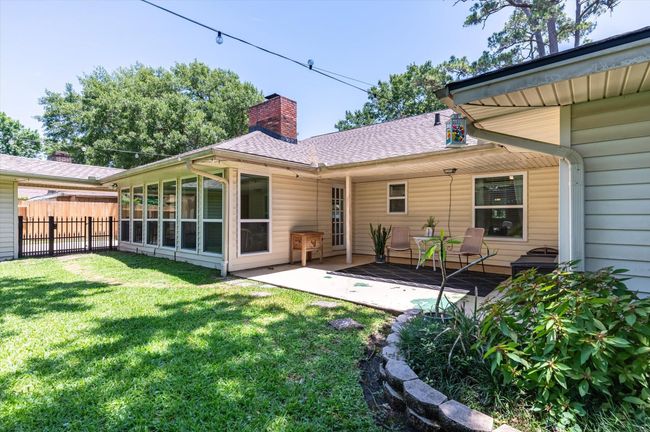 Covered back porch alongside the massive sunroom | Image 7