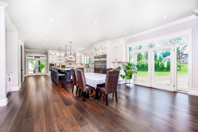 Dining room featuring french doors, crown molding, a wealth of natural light, and dark wood-style floors | Image 9