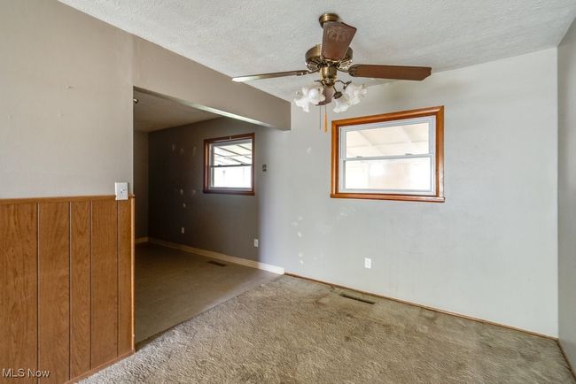 Spare room featuring carpet, a ceiling fan, and a textured ceiling | Image 13