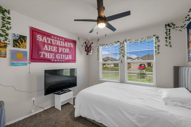 Bedroom with carpet floors, baseboards, and a ceiling fan | Image 26