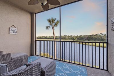 Covered screen-in lanai with beautiful lake and golf course views. | Image 2