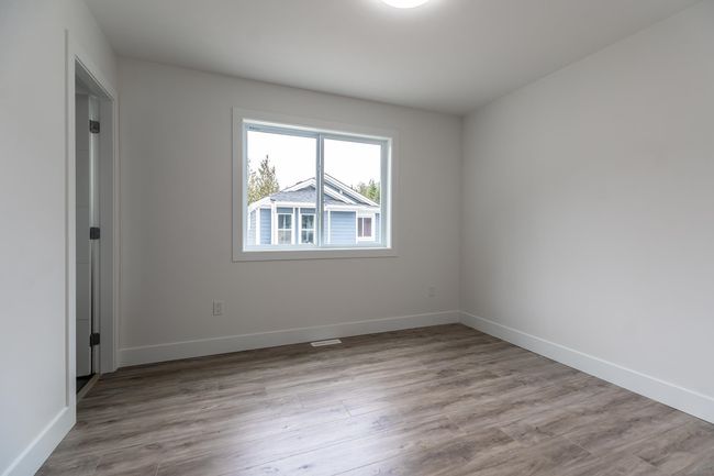 Empty room with wood finished floors and baseboards | Image 25