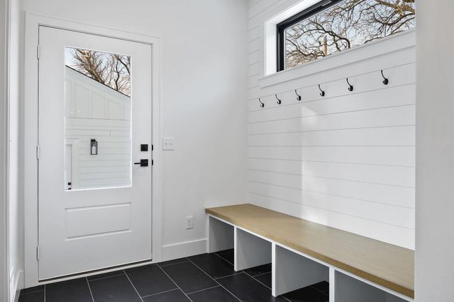 Rear mud room features bench, walk-in coat closet, and powder room. Pictures of previously built house. | Image 14