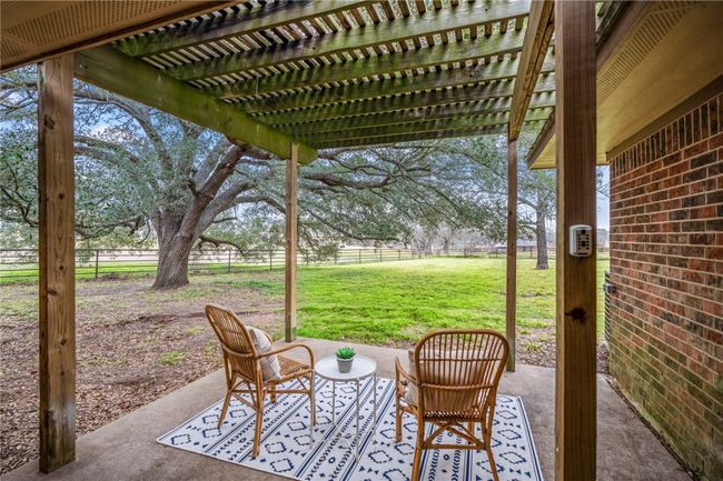 View of patio featuring fence and a pergola | Image 41