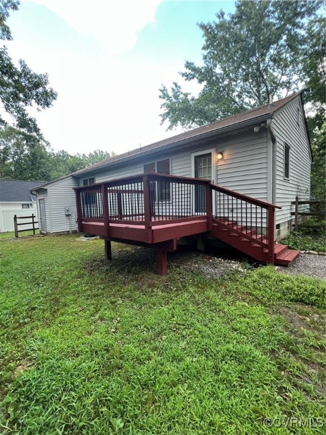 Rear view of house with a deck and crawl space | Image 5