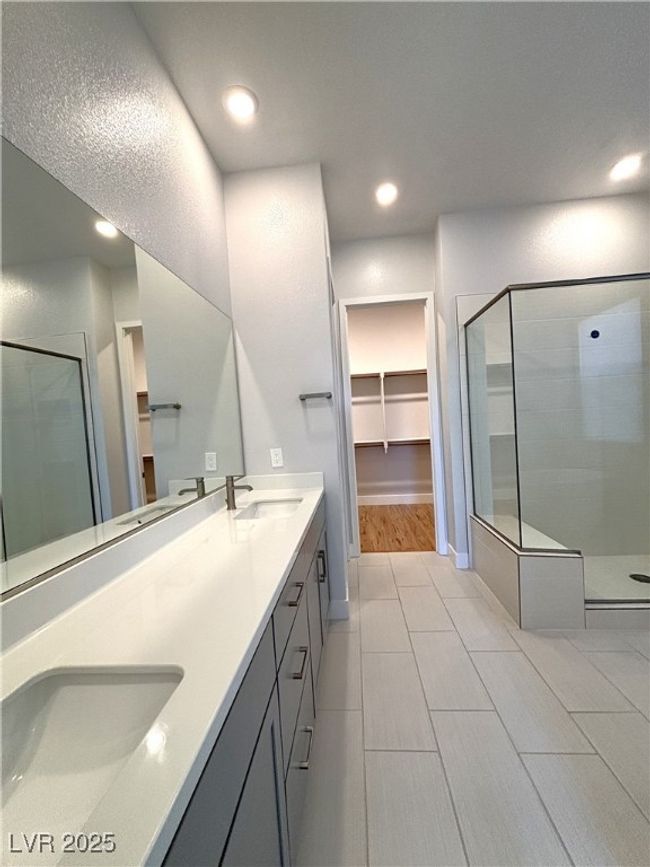 Full bathroom with double vanity, recessed lighting, a stall shower, and a sink | Image 27