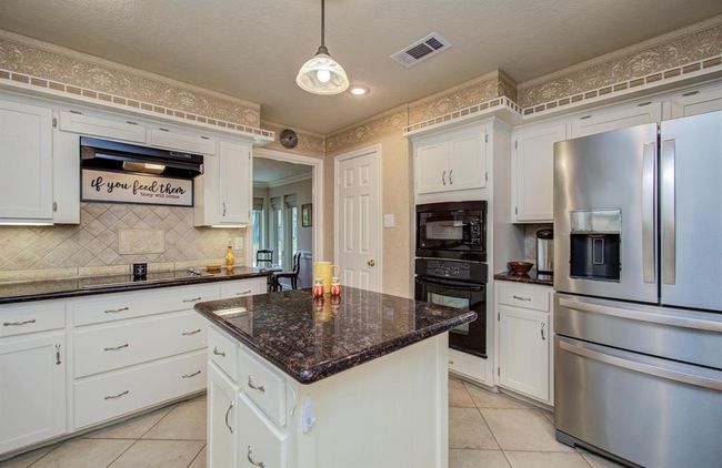 Convenient pot drawers under the smooth glass cooktop. | Image 15