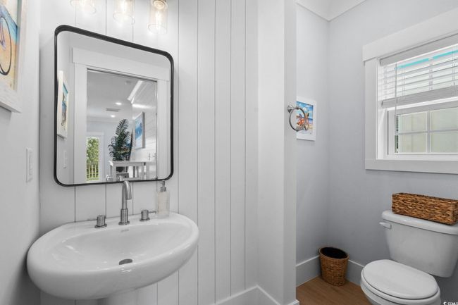 Bathroom featuring a sink and wood finished floors | Image 14