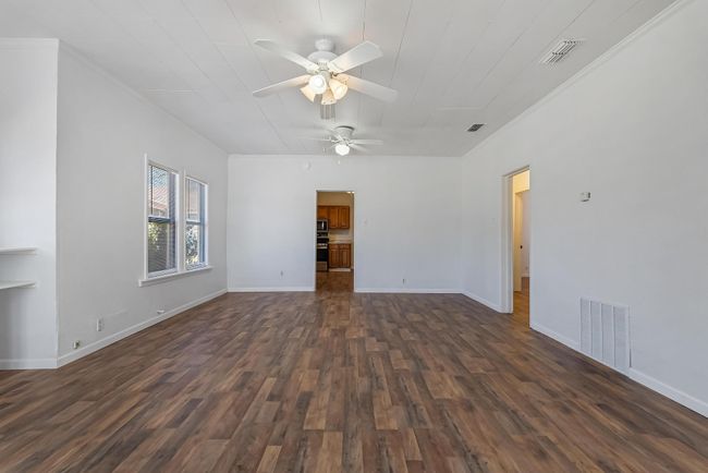 Empty room featuring dark wood-type flooring and ceiling fan | Image 8