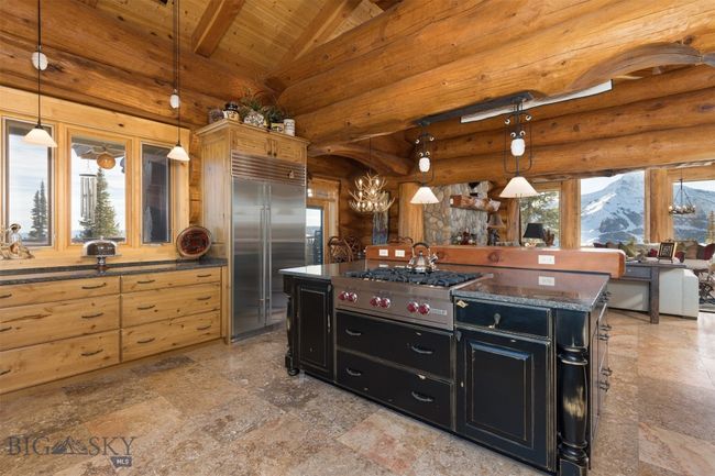 Kitchen to dining and great room, with Lone Mountain and Fan Mountain views beyond. | Image 34
