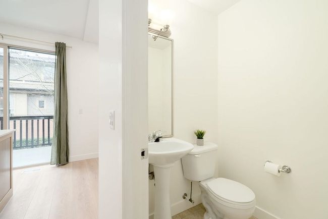 Bathroom with baseboards, toilet, and wood finished floors | Image 20