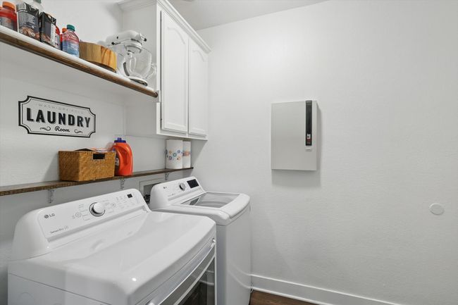 Laundry area with cabinet space, washing machine and clothes dryer, and dark wood-type flooring | Image 32