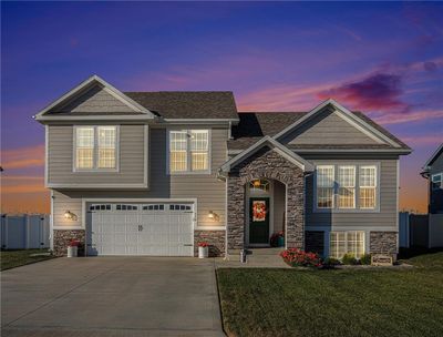 View of front of property with a garage and a lawn | Image 1