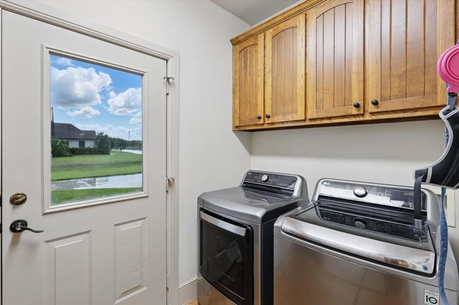 Laundry area with cabinet space and independent washer and dryer | Image 22