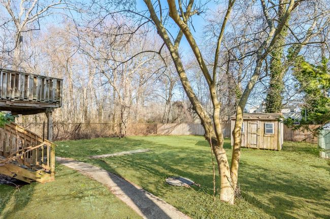 View of yard featuring an outbuilding, a fenced backyard, and a storage unit | Image 33