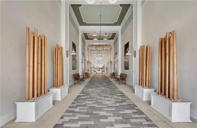 Hallway featuring a towering ceiling, and a tray ceiling | Image 23