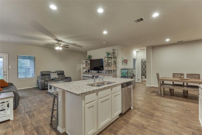 Island kitchen with stainless sink and water filtration system. | Image 25