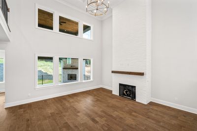 Two story Family Room with a view of the covered patio on the first floor and upstairs, a view of the second story outdoor living space. | Image 3