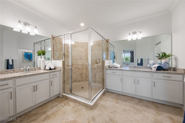 Full bathroom featuring a sink, ornamental molding, two vanities, and a shower stall | Image 8