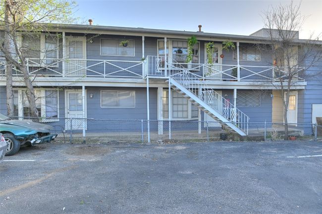 View of front of house featuring stairway, a fenced front yard, and a porch | Image 14