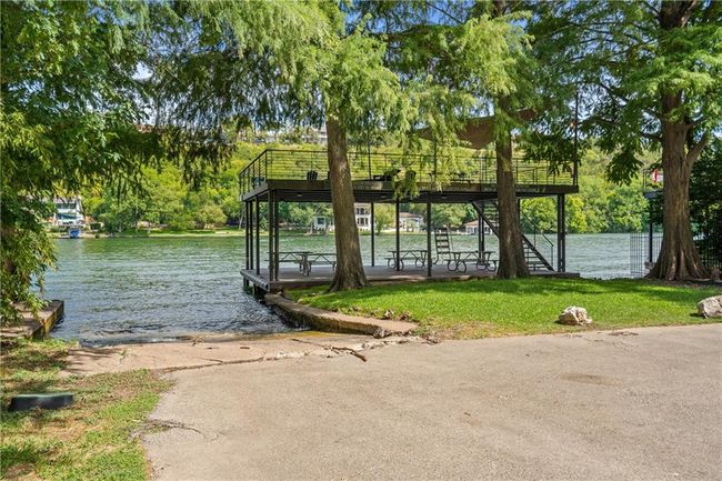 Dock featuring a boat ramp, a water view, and a lawn | Image 25