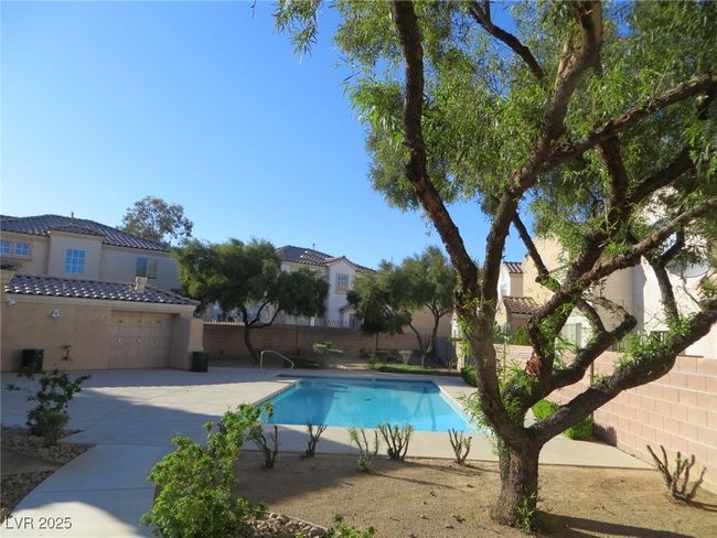 View of swimming pool with fence and a fenced in pool | Image 18