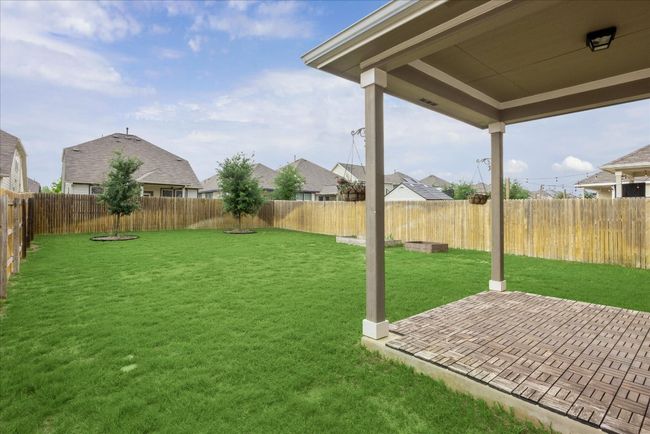 View of yard with a fenced backyard, a patio area, and a residential view | Image 19