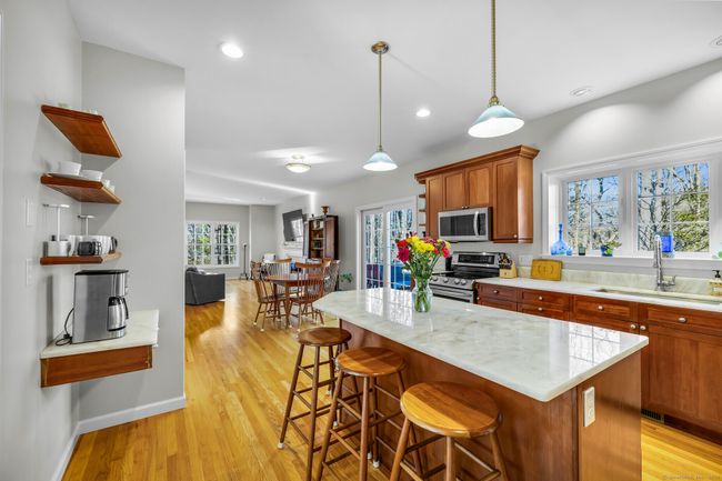 Cabinetry with dovetail feature, dry/coffer bar, boxed window overlooking a serene backyard setting. | Image 10
