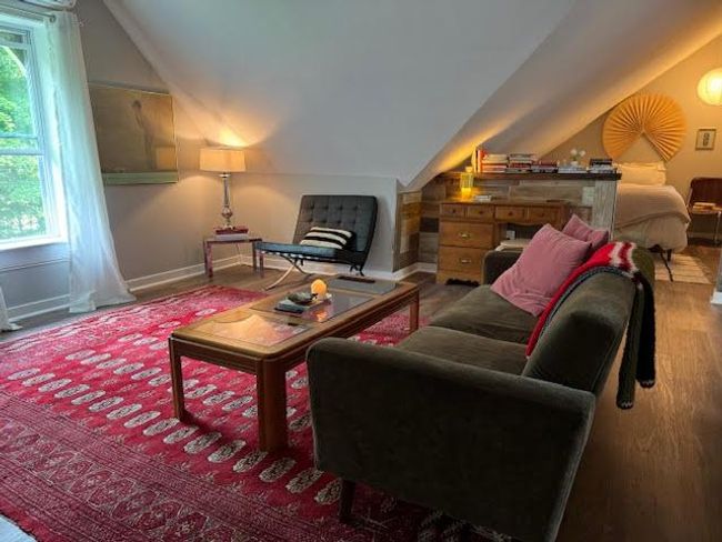 Living area with vaulted ceiling and wood finished floors | Image 26