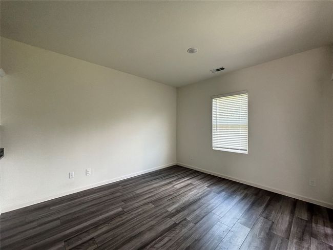 Unfurnished room featuring dark wood-style flooring and baseboards | Image 9