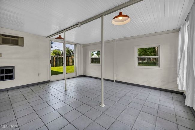 Unfurnished sunroom with a wall mounted air conditioner | Image 36
